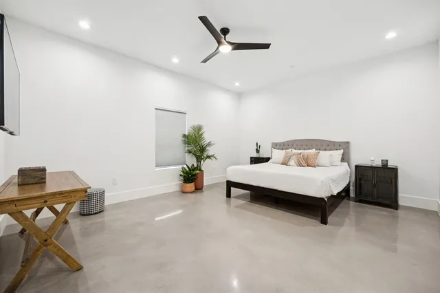 a bedroom with a bed and a table