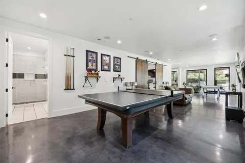 a room with pool table and chairs