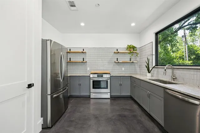 a kitchen with a sink and stainless steel appliances