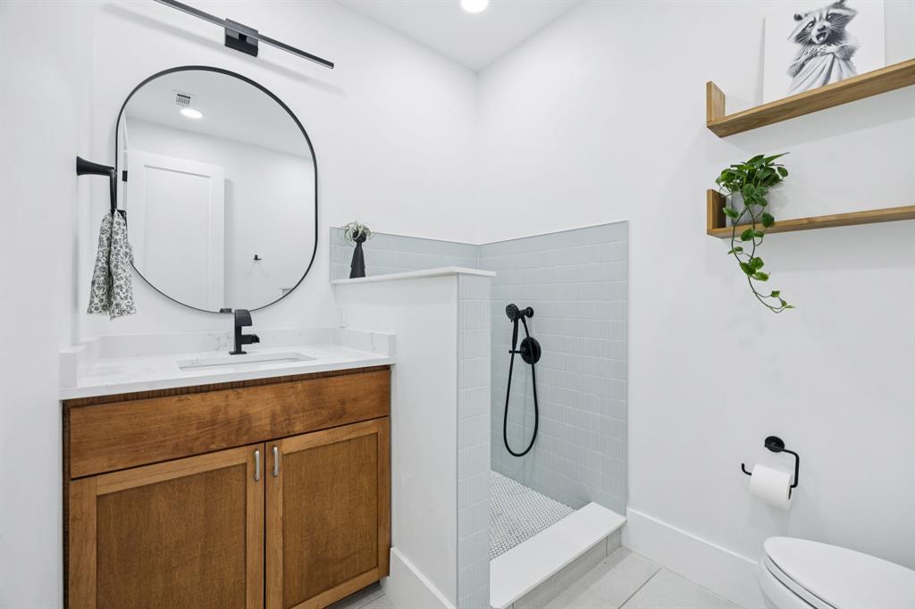 1006 Quail Run Road Southlake, TX 76092 - Photo 16 of 40 a bathroom with a sink a mirror a vanity and toilet