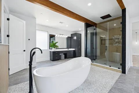 a living room with furniture a mirror and shower