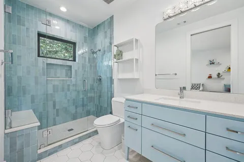 a bathroom with a granite countertop sink a toilet and a bathtub