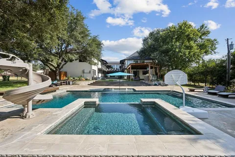 a swimming pool with outdoor seating and yard