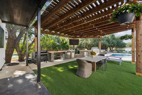 a view of a patio with chairs and a backyard