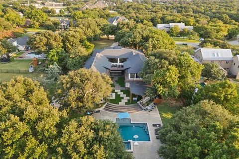 an aerial view of a house with a yard