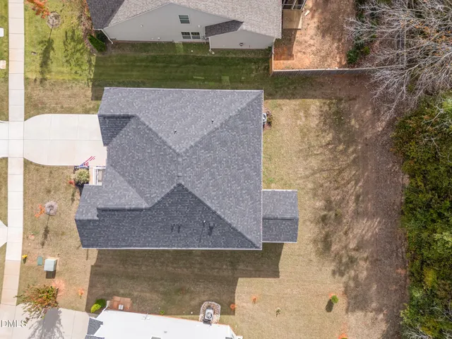 an aerial view of a house with a yard