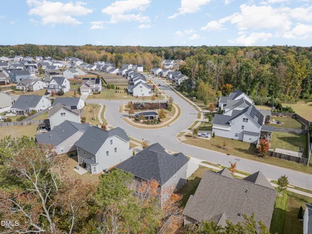 an aerial view of a house with garden space and ocean view