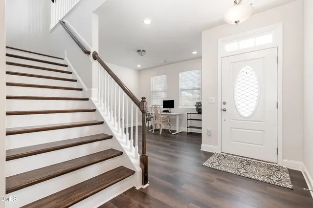 a view of entryway and hall with wooden floor