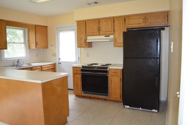 a kitchen with a refrigerator sink and stove