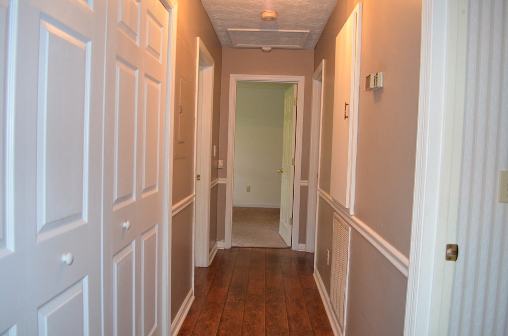 61 Lee Road 0810 Smiths Station, AL 36870 - Photo 6 of 15 a view of a hallway with wooden floor and a glass door