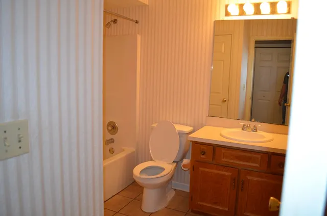 a bathroom with a sink a toilet and shower curtain