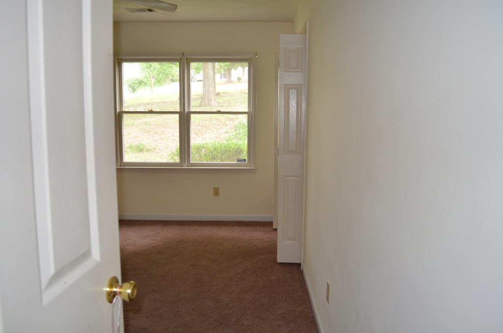 61 Lee Road 0810 Smiths Station, AL 36870 - Photo 8 of 15 a view of a livingroom with an empty space and a window