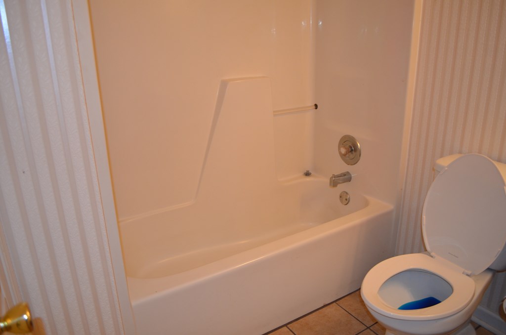 61 Lee Road 0810 Smiths Station, AL 36870 - Photo 10 of 15 a white bath tub sitting next to a white toilet
