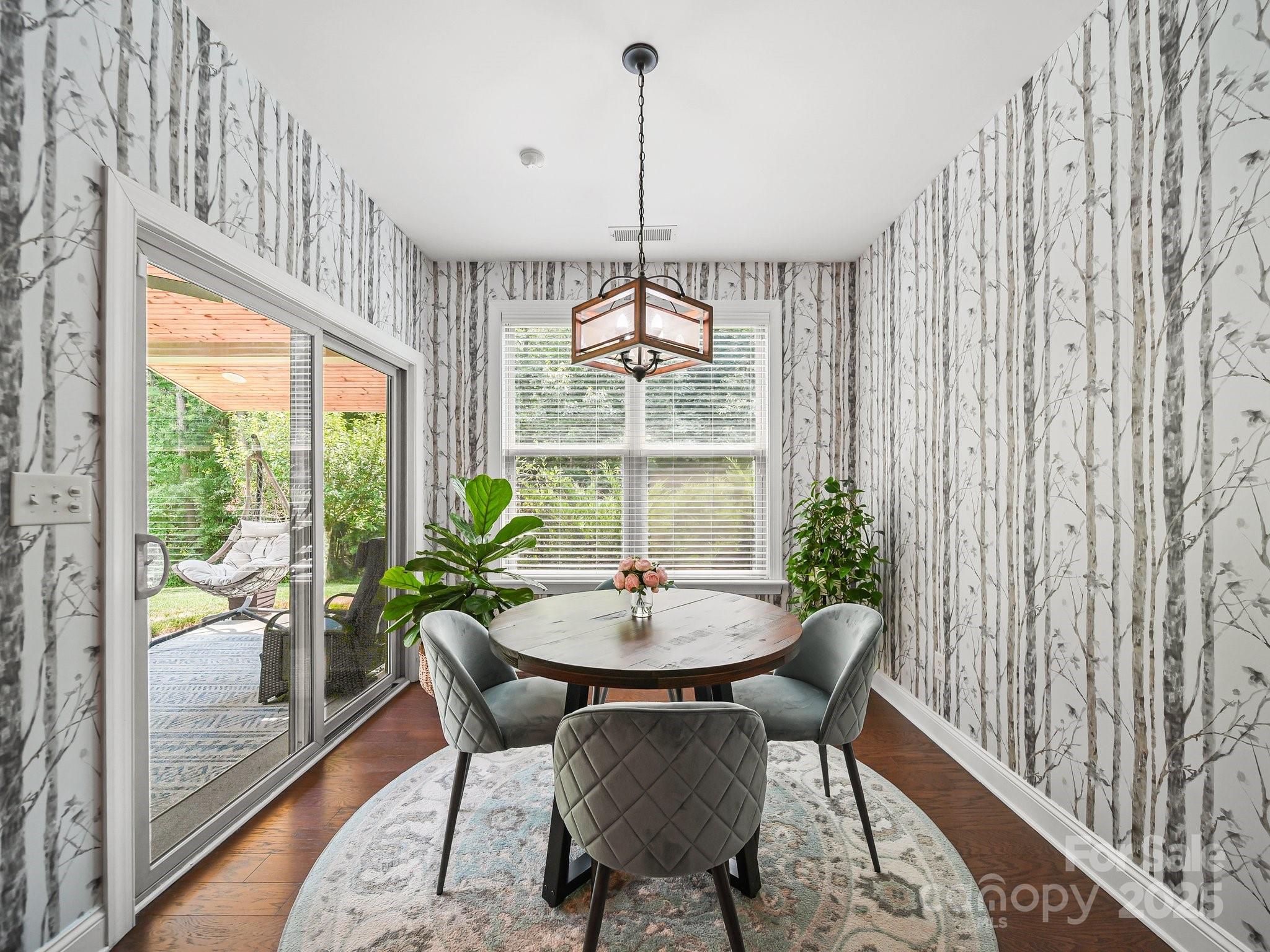 9639 Estridge Lane Concord, NC 28027 - Photo 21 of 48 a dining room with furniture a chandelier and wooden floor