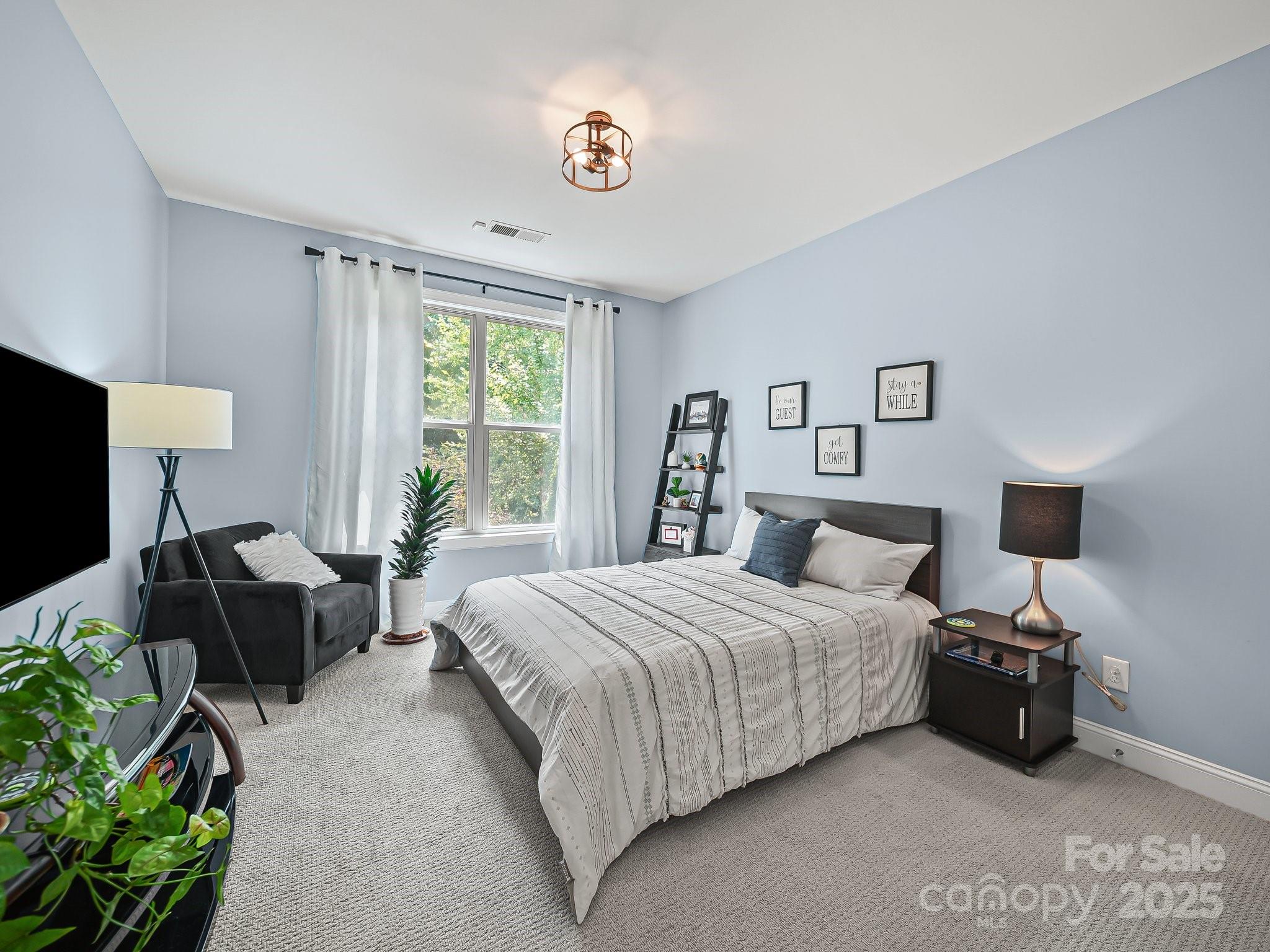 9639 Estridge Lane Concord, NC 28027 - Photo 22 of 48 a spacious bedroom with a bed and a couch