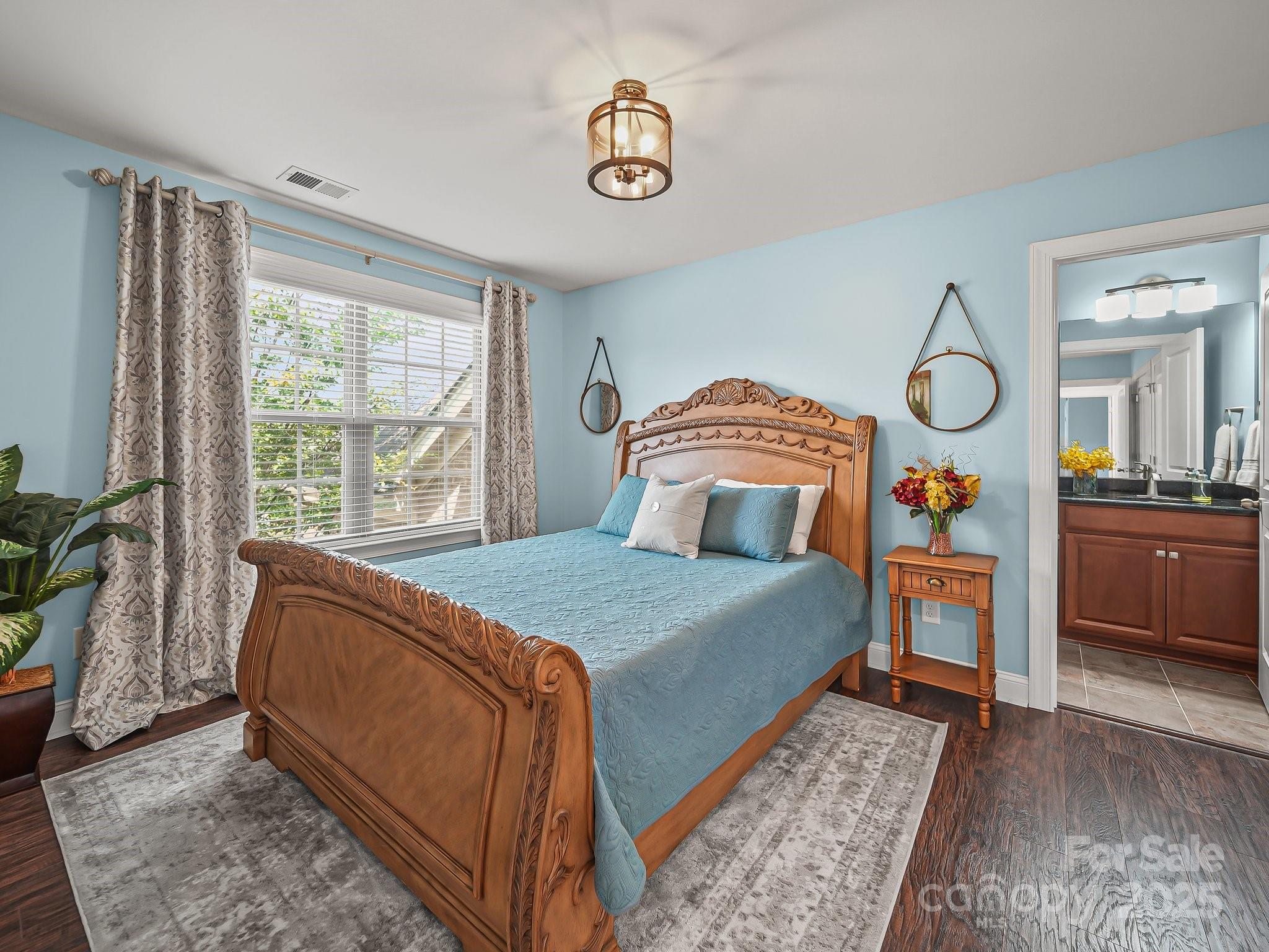 9639 Estridge Lane Concord, NC 28027 - Photo 27 of 48 a bedroom with a large bed and a chandelier