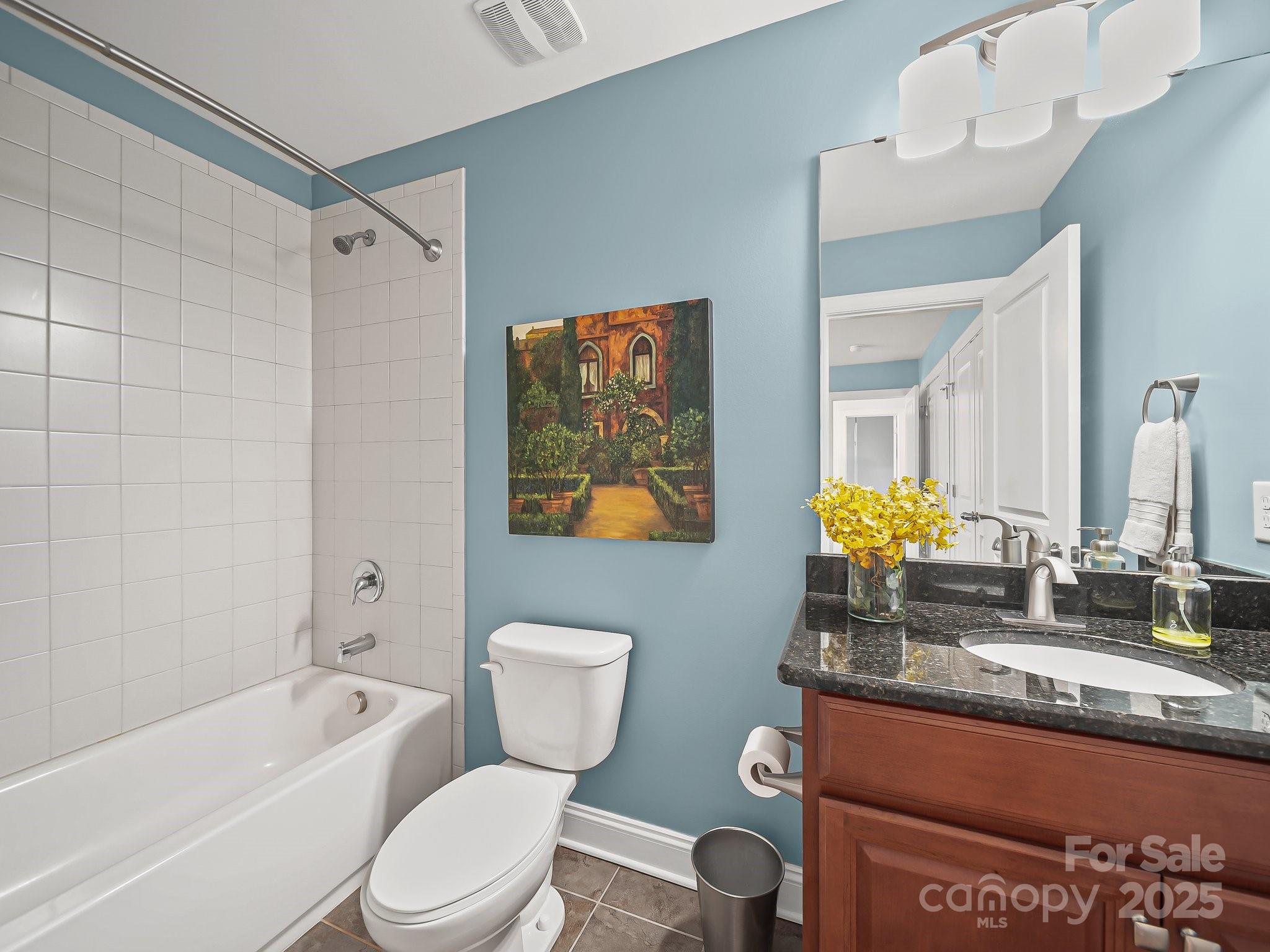 9639 Estridge Lane Concord, NC 28027 - Photo 28 of 48 a bathroom with a granite countertop bathtub sink vanity mirror and toilet