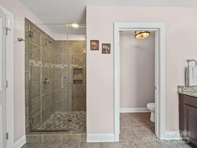 a bathroom with a shower and a toilet