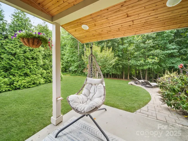 a view of a chair and table in the garden