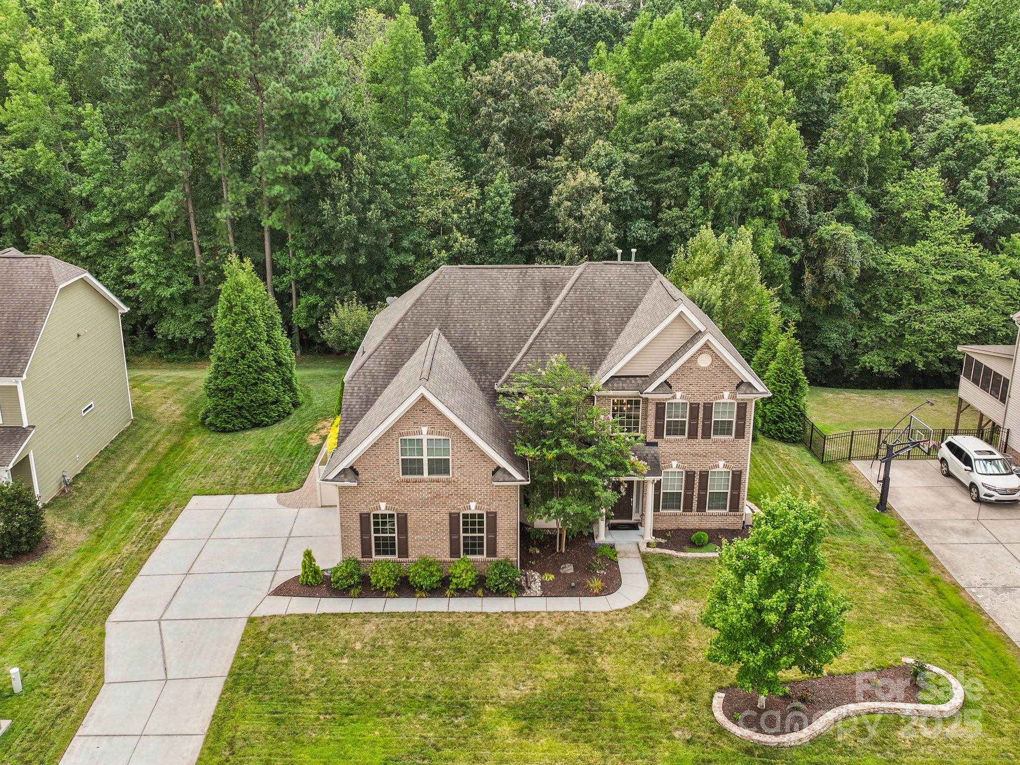 9639 Estridge Lane Concord, NC 28027 - Photo 4 of 48 a aerial view of a house with swimming pool next to a yard