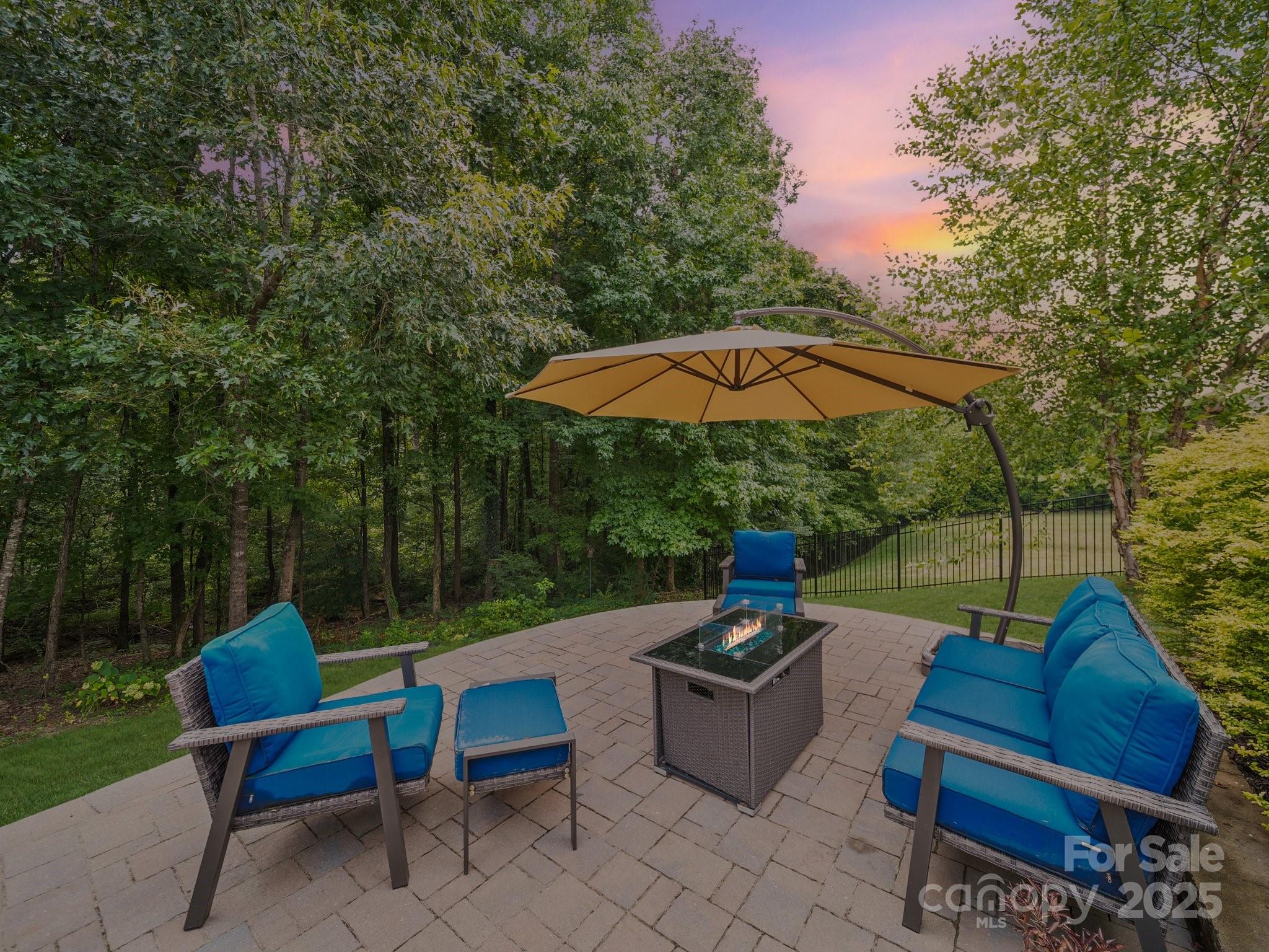 9639 Estridge Lane Concord, NC 28027 - Photo 42 of 48 an outdoor sitting area with furniture and umbrella