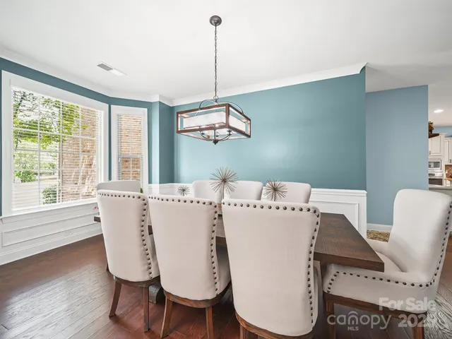 a view of dining room with furniture window and wooden floor