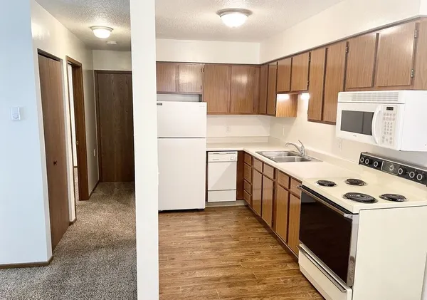 a kitchen with a stove a refrigerator and a sink