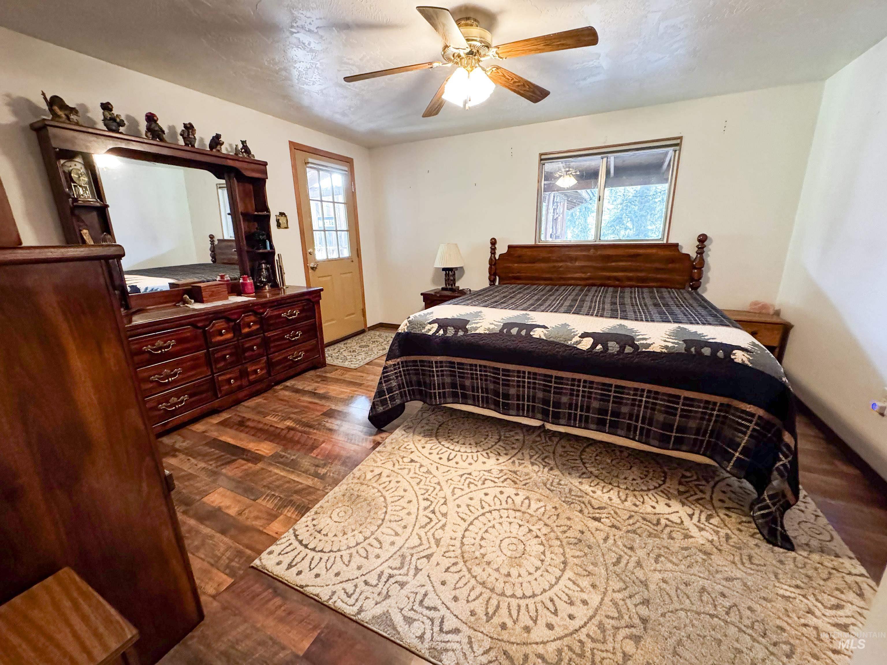 4482 Council Cuprum Road Council, ID 83612 - Photo 10 of 45 Bedroom with dark wood-style floors, ceiling fan, and a textured ceiling