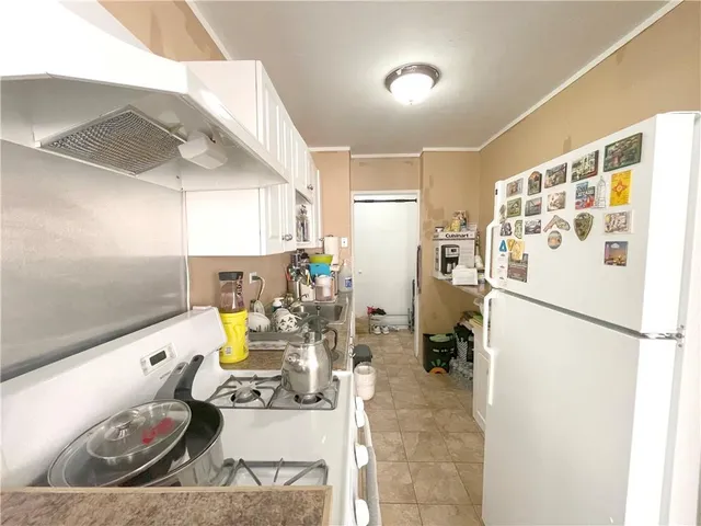 a kitchen with a refrigerator and a stove