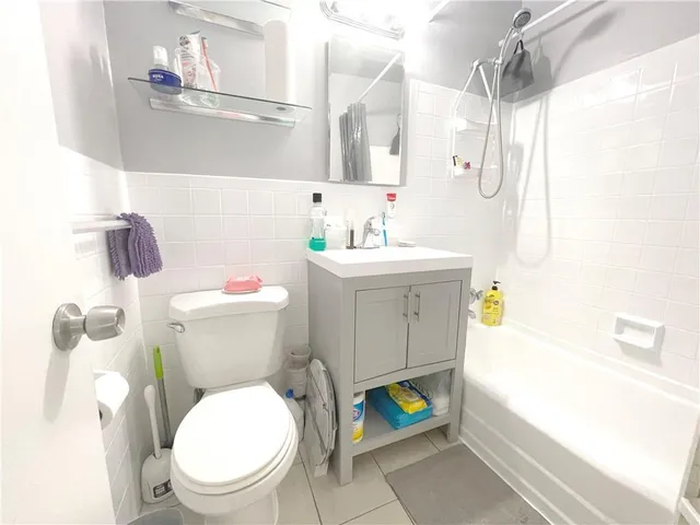 a bathroom with a sink vanity mirror and shower