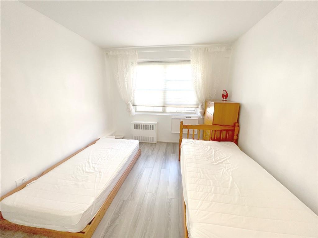 2940 West 5th Street, Unit 14C Brooklyn, NY 11224 - Photo 18 of 26 a living room with a bed furniture and a large window
