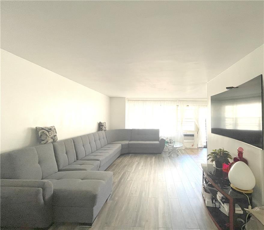 2940 West 5th Street, Unit 14C Brooklyn, NY 11224 - Photo 2 of 26 a living room with furniture and a wooden floor