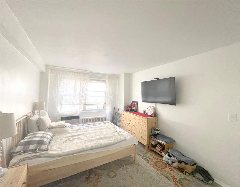 2940 West 5th Street, Unit 14C Brooklyn, NY 11224 - Photo 22 of 26 a bedroom with a bed and a flat screen tv