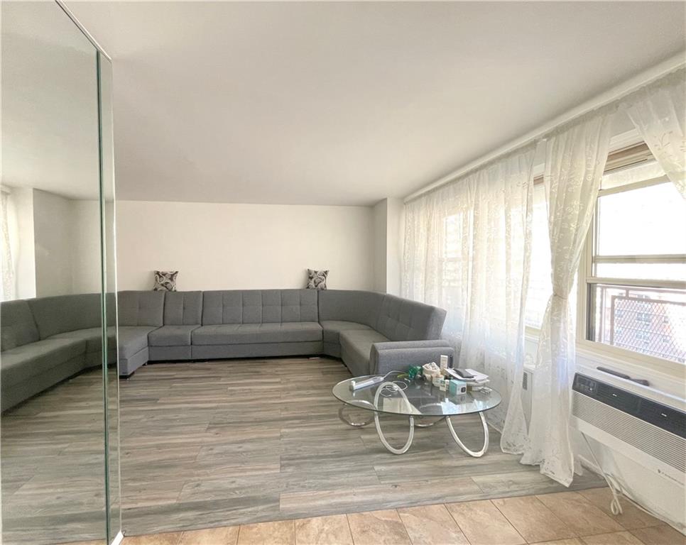 2940 West 5th Street, Unit 14C Brooklyn, NY 11224 - Photo 7 of 26 a living room with furniture and a large window