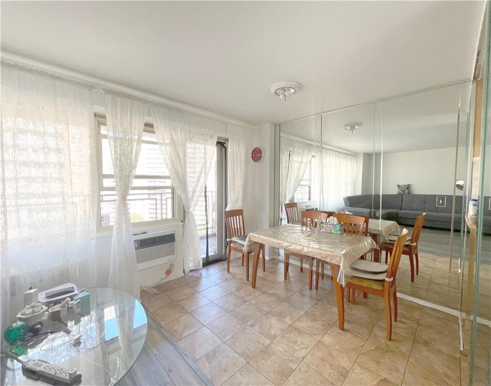 2940 West 5th Street, Unit 14C Brooklyn, NY 11224 - Photo 9 of 26 a room with lots of tables a chair and glass door