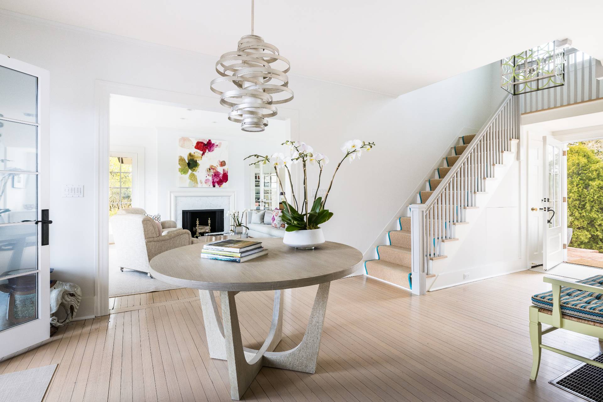 17 Apaquogue Road East Hampton, NY 11937 - Photo 13 of 37 a view of a dining room with furniture a chandelier and wooden floor