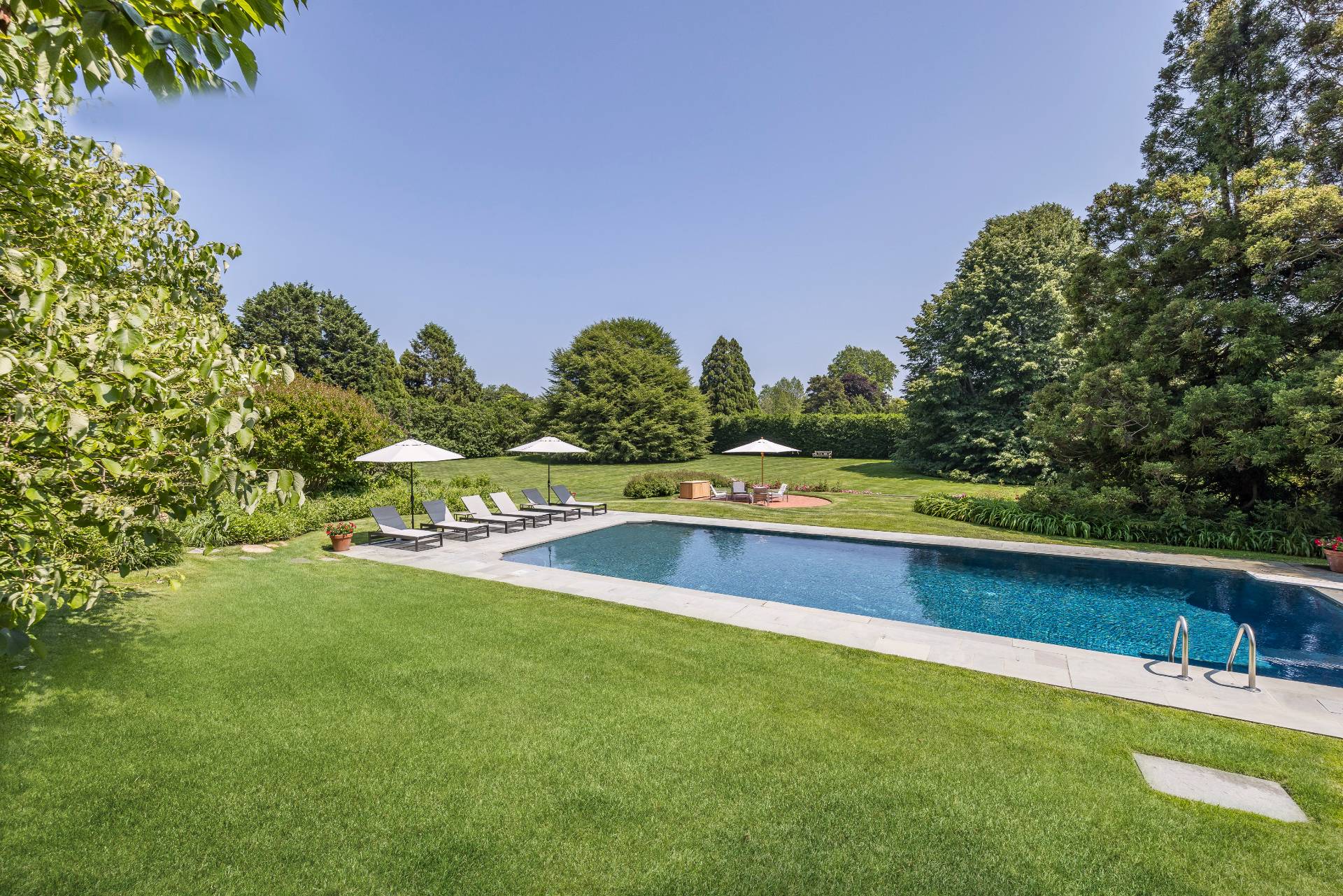 17 Apaquogue Road East Hampton, NY 11937 - Photo 3 of 37 a view of a lake with houses in the back