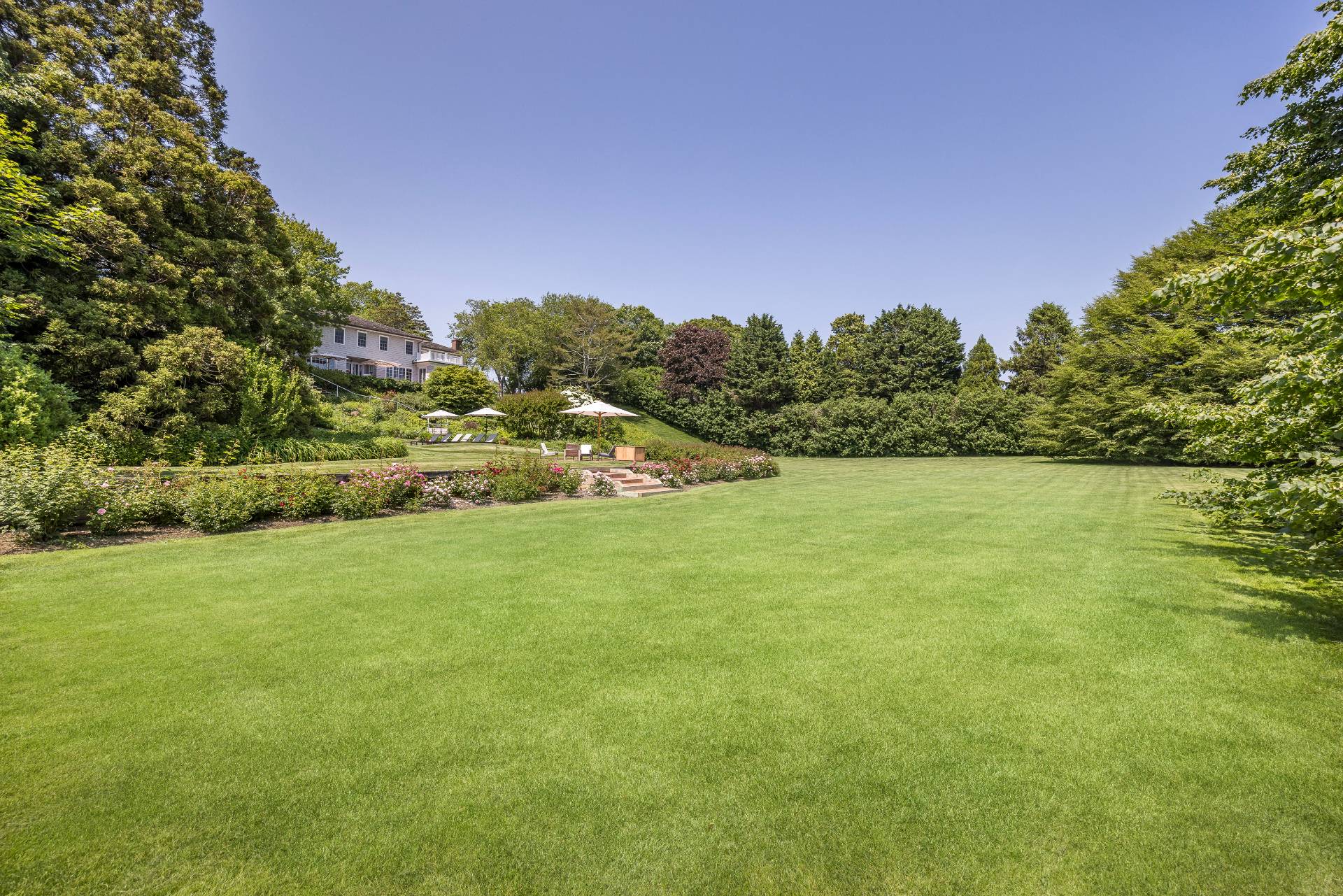17 Apaquogue Road East Hampton, NY 11937 - Photo 36 of 37 a view of a big yard with a house in the background