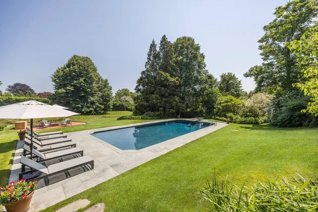 a view of a yard with a swimming pool