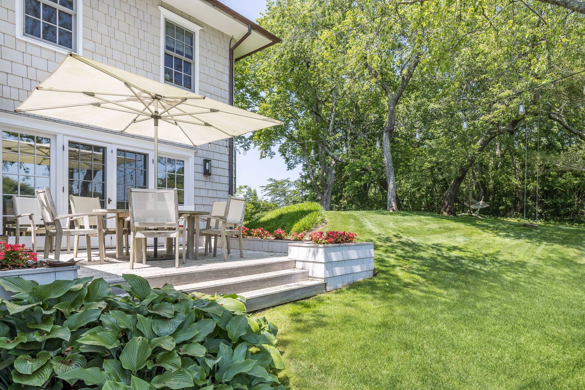 17 Apaquogue Road East Hampton, NY 11937 - Photo 8 of 37 a view of house with backyard outdoor seating and green space