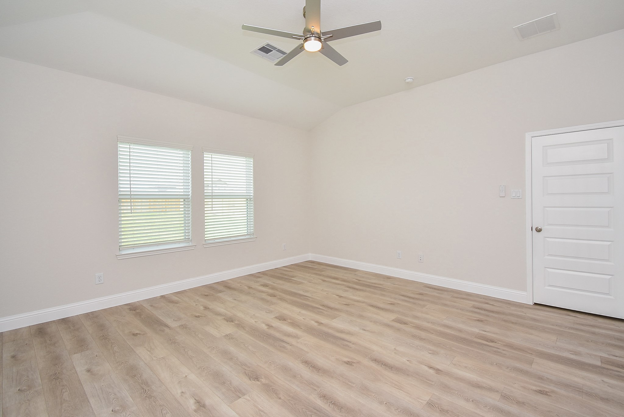 7230 Toluca Drive Rosharon, TX 77583 - Photo 11 of 27 an empty room with wooden floor ceiling fan and windows