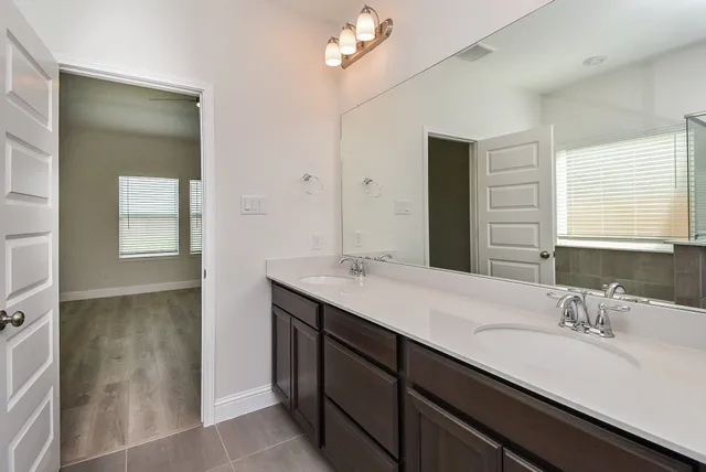 a bathroom with a sink double vanity and a mirror