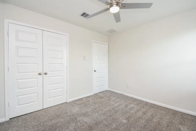 an empty room with a ceiling fan