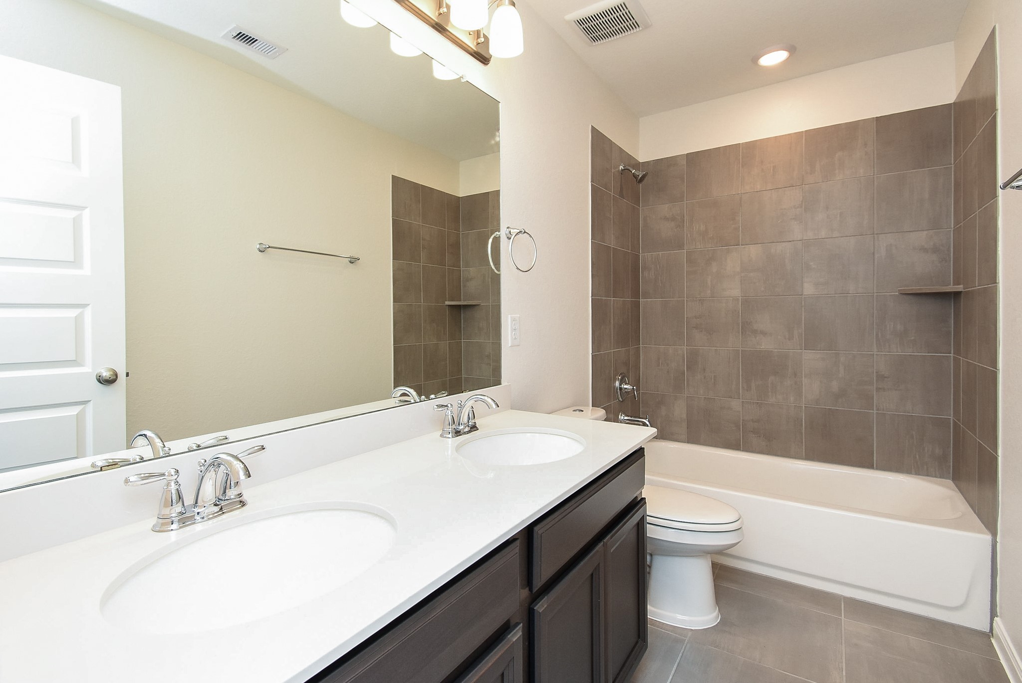 7230 Toluca Drive Rosharon, TX 77583 - Photo 24 of 27 a bathroom with a bathtub shower sink mirror vanity and toilet