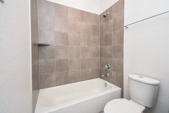 a white bath tub sitting next to a white toilet