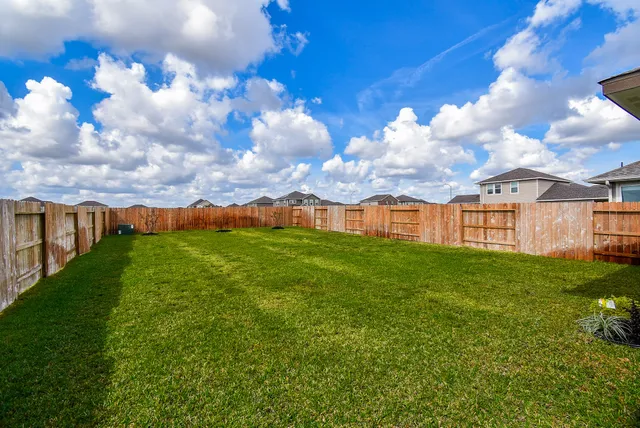 a view of a big yard with lots of green space