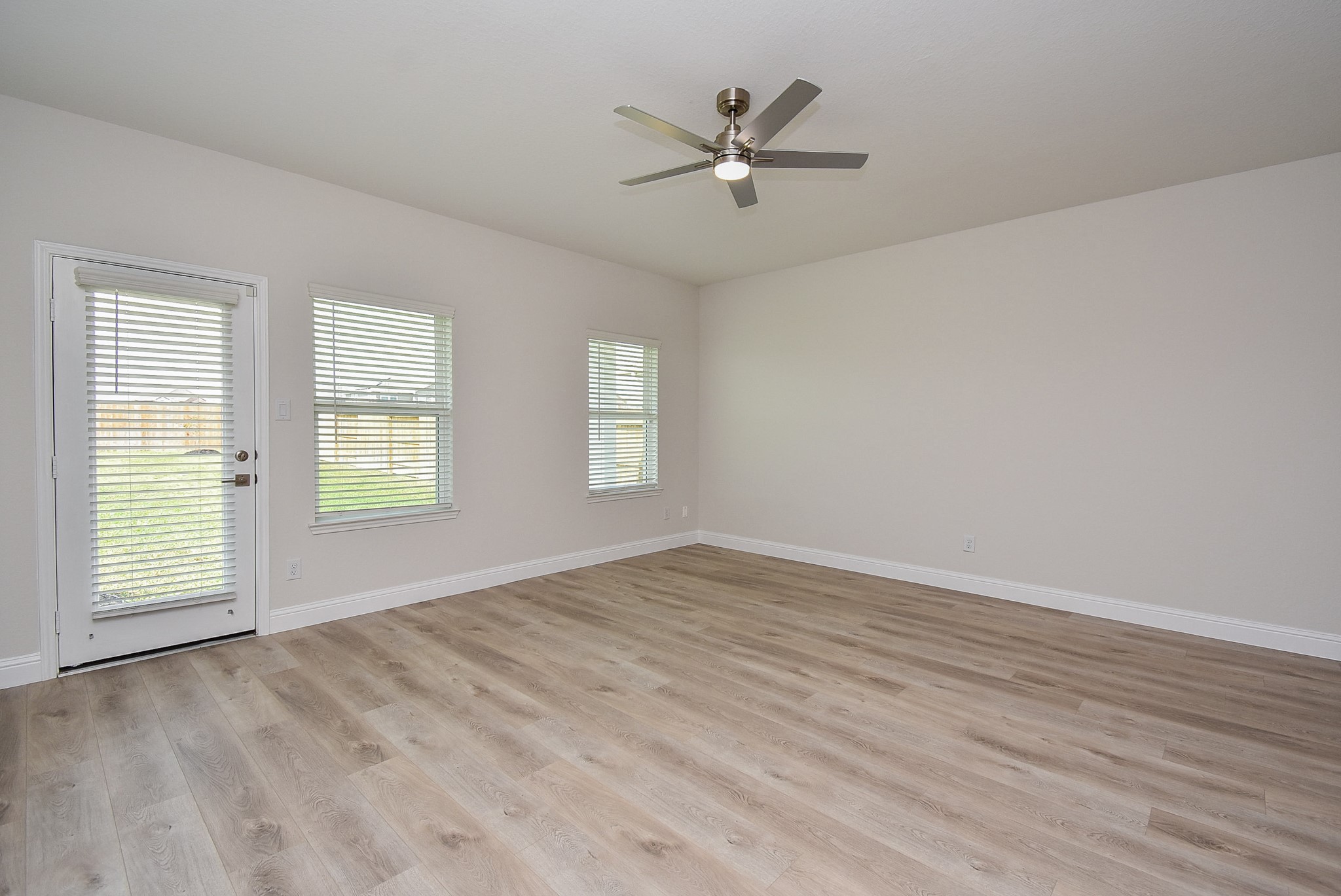 7230 Toluca Drive Rosharon, TX 77583 - Photo 6 of 27 a view of empty room with wooden floor and fan
