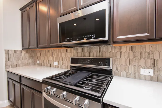 a stove top oven sitting inside of a kitchen