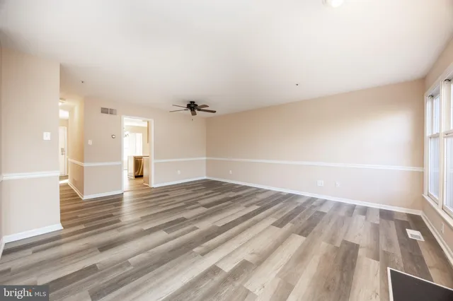 a view of an empty room and wooden floor