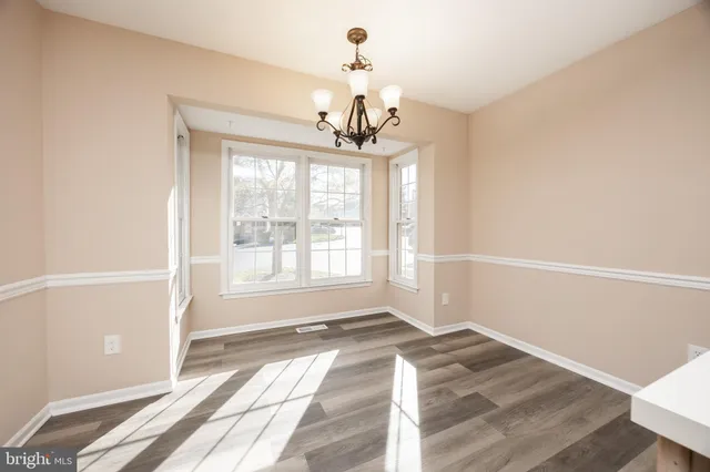 a view of a room with wooden floor and windows